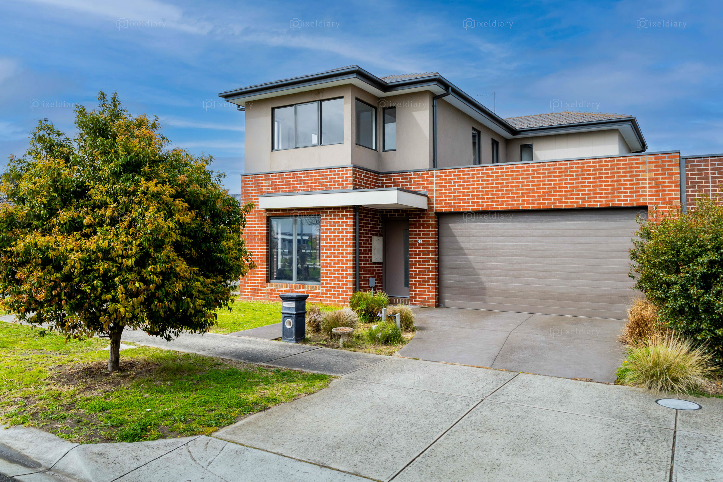 Modern brick home exterior framed by landscaping