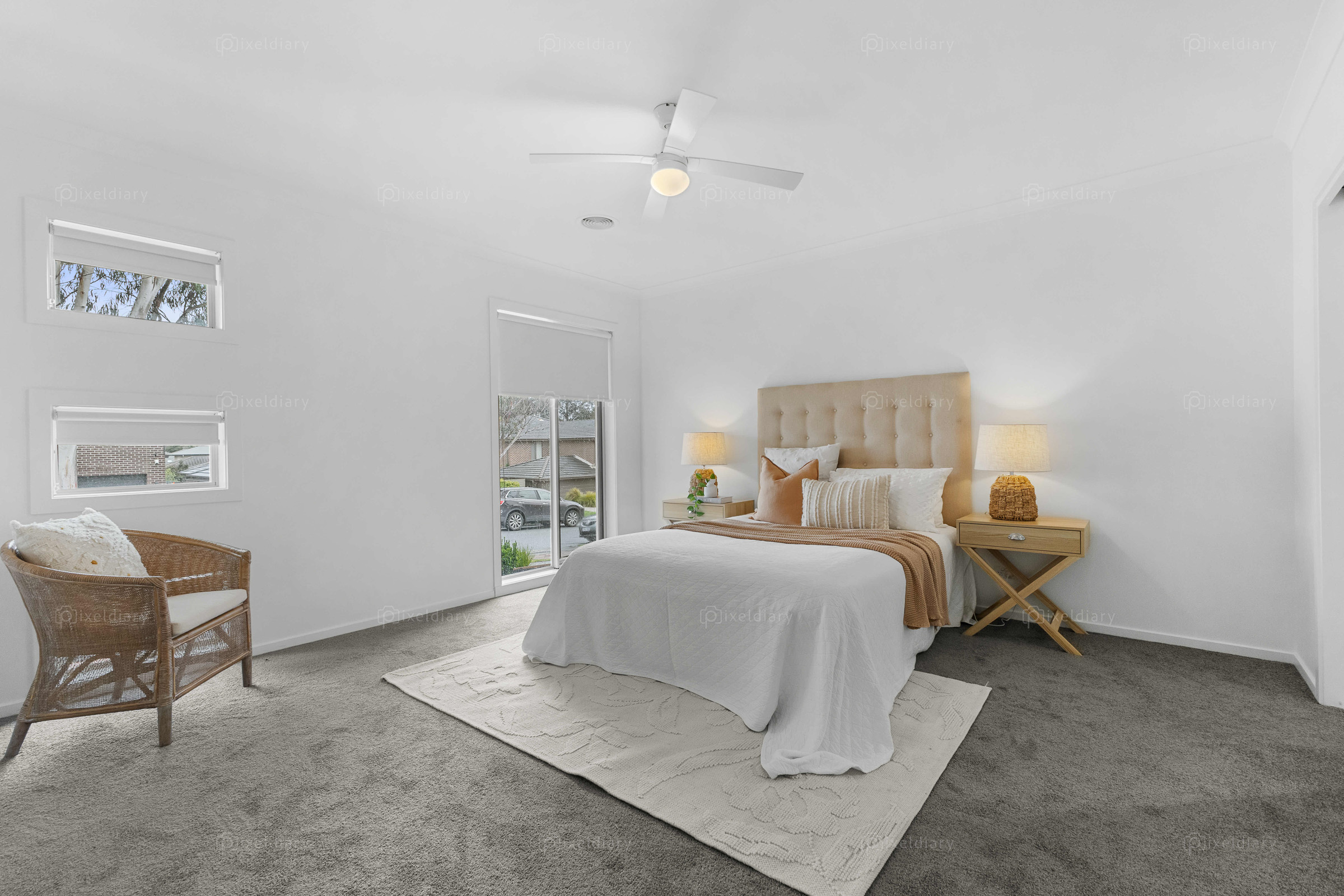 Spacious neutral bedroom with layered styling