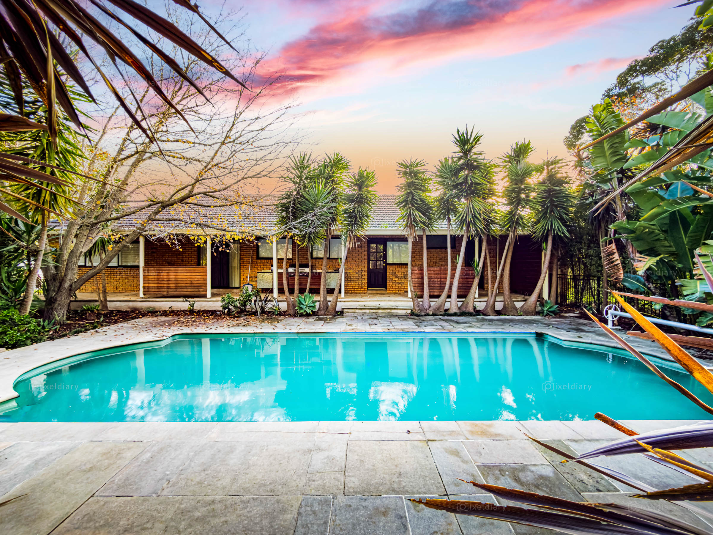 Pool and landscaped garden at sunset